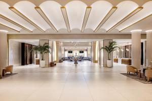 a lobby of a hotel with a large ceiling at Caesars New Orleans, A Caesars Rewards Destination in New Orleans