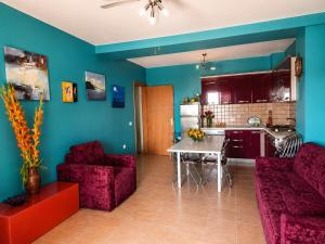 a living room with a couch and a table and a kitchen at Sea view apartment 2 in Skataj
