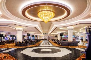 a large lobby with a large chandelier and a casino at Caesars New Orleans, A Caesars Rewards Destination in New Orleans