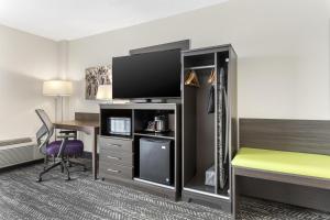 a hotel room with a bed and a desk with a television at Best Western Plus Wausau Tower Inn in Wausau