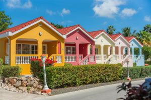 a row of colourful houses in a street at Sonesta Hotels & Resorts Livingstone Curacao in Willemstad
