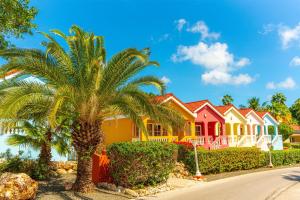 a row of houses with palm trees in front at Sonesta Hotels & Resorts Livingstone Curacao in Willemstad +130 photos