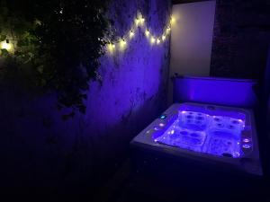 a dark room with a lit up room with lights at La Maison Cabane in Cholet