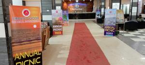 a aisle with a red carpet in a store at Epindi Studio Apartment in Cox's Bazar