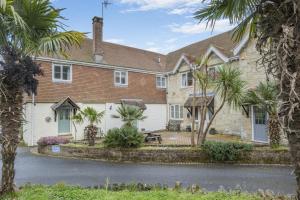 a house with palm trees in front of it at 2 Bed in Shanklin oc-c36037 in Shanklin
