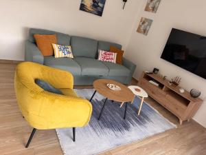 a living room with a couch and a table at HiL's Bay View Apartments in Tivat