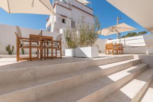 a set of stairs with chairs and tables at Enea Dimora Procida in Procida