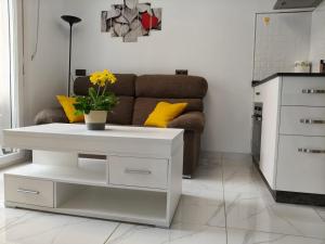 a white coffee table in a living room with a couch at Apartamentos Dali 1 in Guadix