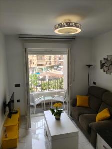 a living room with a couch and a table at Apartamentos Dali 1 in Guadix