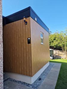 a wooden building with a light on the side of it at Nivahana in Edinburgh