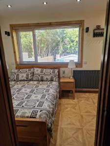 a bedroom with a bed and a large window at Nivahana in Edinburgh