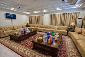 a large living room with couches and a tv at Comfort Family Lodges Islamabad in Islamabad