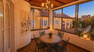 a dining room with a table and chairs and a large window at Les jardins d'Elise in Lure