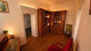 a living room with wooden floors and a wooden cabinet at Les jardins d'Elise in Lure