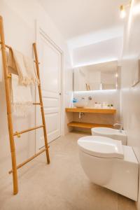 a bathroom with a white toilet and a ladder at Enea Dimora Procida in Procida +41 photos