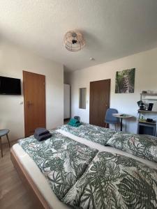 a bedroom with a bed with a green and white comforter at Gästehaus Gute Quelle in Cochem +40 photos
