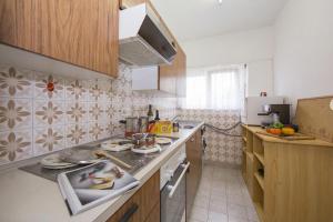 a kitchen with a sink and a counter top at Aldesago Panoramica with shared Pool and Lugano View - Happy Rentals in Aldesago