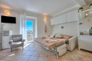 a bedroom with a bed and a chair in it at Nido Belvedere AC and Lake View - Happy Rentals in Lesa