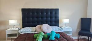a bed with two pillows on it with two lamps at Rooms Flor del Pato in Benalmádena