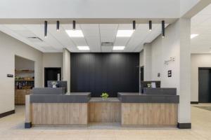 a lobby with a waiting area with a large wall at Best Western Plus Neepawa Hotel in Neepawa +60 photos