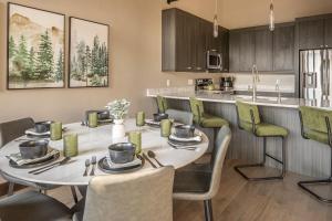 a kitchen and dining room with a table and chairs at Alpenglow Condo 26A in Big Sky