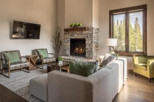 a living room with a couch and a fireplace at Alpenglow Condo 26A in Big Sky