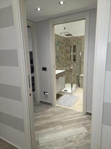 a bathroom with a tub and a sink and a mirror at Living Monza Arengario in Monza