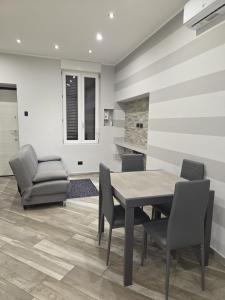 a dining room with a table and chairs at Living Monza Arengario in Monza