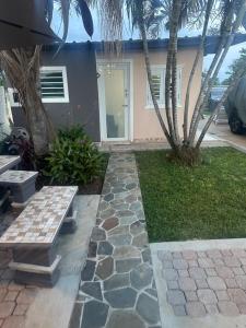 a house with a stone walkway in front of it at Los Machos surf shack in Ceiba +6 photos