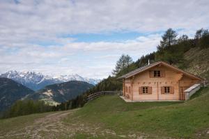 a house on a hill with mountains in the background at Riggeralm in Rangersdorf +44 photos