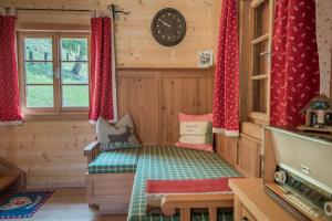 a small room with a bed in a wooden house at Riggeralm in Rangersdorf