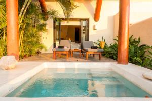 a swimming pool in the middle of a house at Tentaciones Boutique Hotel - Ocean View & Private Pools - Adults Only in Zihuatanejo