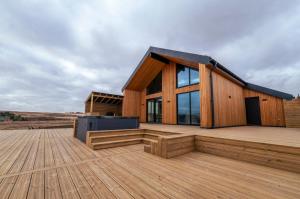 a wooden house on a wooden deck at Modern Aurora Retreat in Selfoss