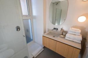 a bathroom with a sink and a shower with a mirror at B612 Bariloche in San Carlos de Bariloche +63 photos