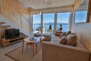 a living room with a couch and a television at B612 Bariloche in San Carlos de Bariloche