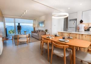 a kitchen and living room with a table and chairs at B612 Bariloche in San Carlos de Bariloche
