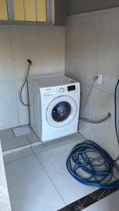 a washing machine sitting on the floor in a room at Vista Bela Guesthouse in Barra do Garças +2 photos