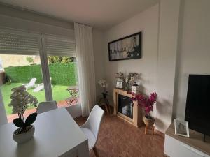 a living room with a table and a fireplace at Las Candelas, Casa Turística in Uruñuela