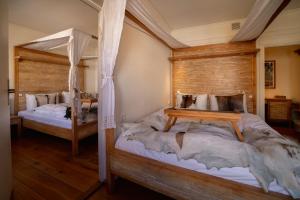 two beds in a bedroom with wooden walls at Oslo Guldsmeden in Oslo