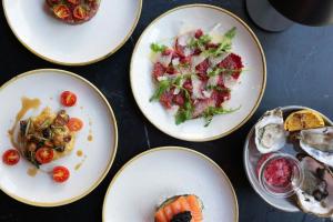 a table with four plates of food on it at Axel Guldsmeden in Copenhagen