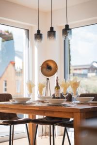 a dining room table with glasses and a bottle of wine at Fernruh Eifel in Dahlem