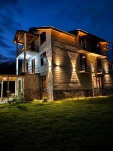 a house at night with the lights on at Ninama in Mestia