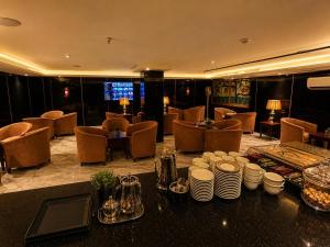 a hotel lobby with a table with plates and cups at سرايا الغربية للشقق المخدومة - saraya algharbiyya Establishment in Jeddah