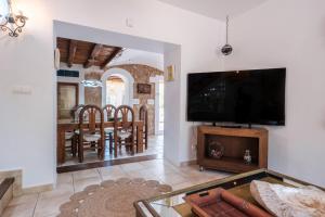 a living room with a large flat screen tv at Villa Alba in Santa Eularia des Riu