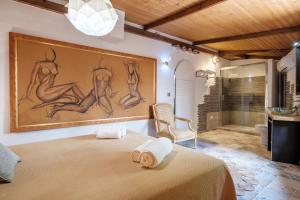 a bedroom with a bed with a painting on the wall at Villa Alba in Santa Eularia des Riu +27 photos