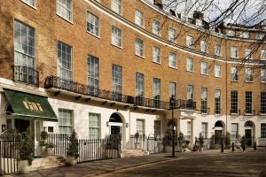 a large brick building with a sign in front of it at Montcalm Mayfair, Autograph Collection in London