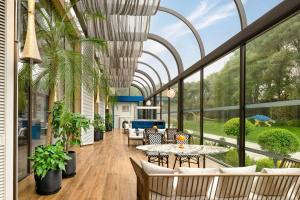 a living room with a large glass ceiling at Le Méridien Changzhou in Changzhou