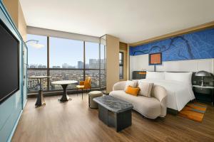 a hotel room with a bed and a couch at Le Méridien Changzhou in Changzhou