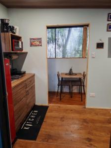 a small kitchen with a table and a window at La Casita Verde in Boquete +46 photos