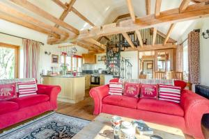 a living room with two red couches and a kitchen at 2 Bed in Dorchester oc-dc075 in Charminster